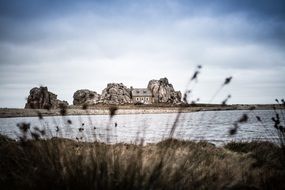 old house on scenic rocky island, france, bretagne