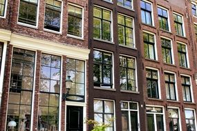 many windows on the facade of a house in amsterdam