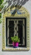 window with flower pot in greece architecture