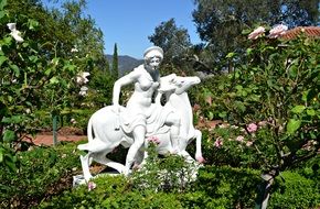 female statue on the horse in a garden