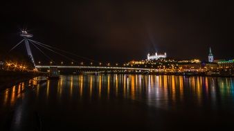 photo of lighting bridge Bratislava city at night