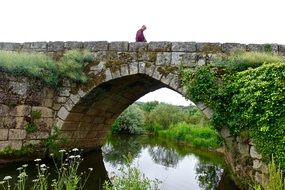 man on a beautiful old brick bridge