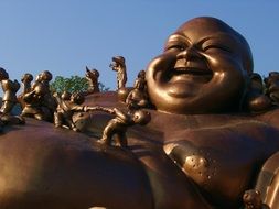 bronze statues of Buddha smile