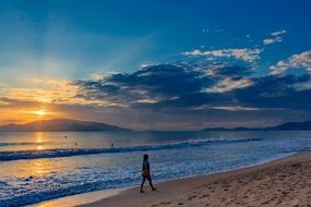 walking person on the sea shore