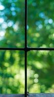 black metal frame of window close up on a blurred background