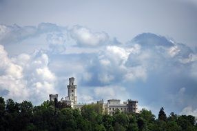 distant view of the Hluboka nad Vltavou Castle among the trees