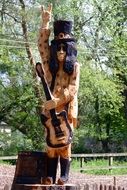 rock star like wooden carved sculpture
