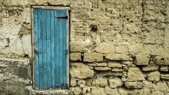 blue wooden door to a brick building