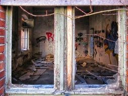 grunge interior of abandoned industrial Building through broken Window