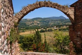 picturesque landscape through an arched opening