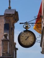 clock on the wall of the church on the street