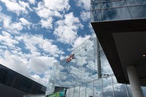 Modern glass building on a background of clouds