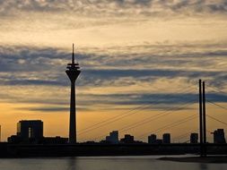 distant view of the tv tower in dusseldorf at sunset