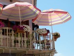 balconies with umbrellas and flowers in sunny albania