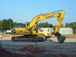 big yellow Excavator stands on ground