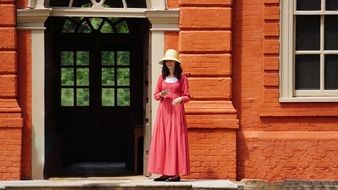 girl in red dress standing near the door