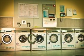 row of Washing Machines at wall in Launderette