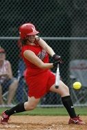 softball player in red uniform on the field