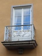 forged balcony on the facade of the building