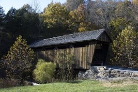 covered wooden bridge over the river