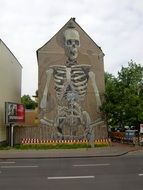 skeleton graffiti on the facade of the city building