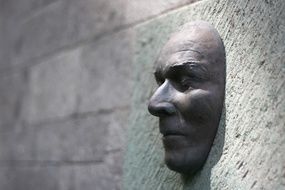 male Face, Sculpture on stone wall, spain, Canary Islands