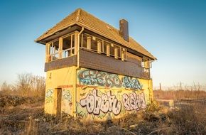 damaged building with graffiti on walls