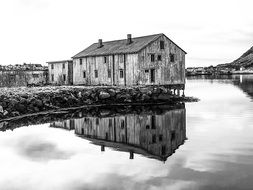 house is reflected in the water on the Lofoten Islands