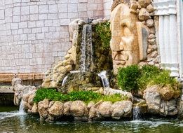 waterfall near a building in mexico