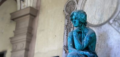 sculpture of a woman on the facade of the building