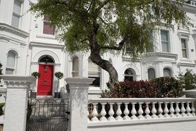 elegant house with red entrance doors in london