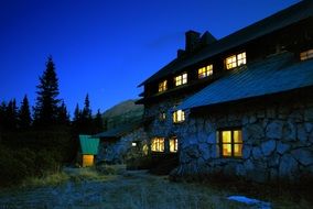 light in the windows on the stone building