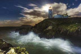 scenic lighthouse on the cliff coast in Ireland