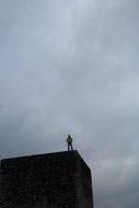 man on top of a wall of Roman fort in Irgenhausen, Switzerland