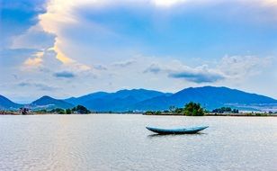 empty blue boat on water at scenic tranquil landscape