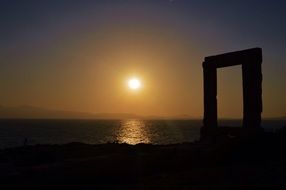 Sunset above Island in dark Sea, Greece, cyclades