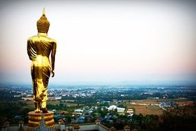 golden statue and buildings in Nan Province, Thailand