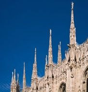 ornate spires of Gothic Cathedral at blue sky