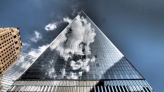 reflection of clouds on the facade of a skyscraper