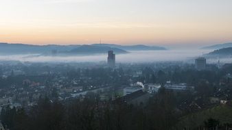 panorama of the vibrant city of Winterthur at foggy dusk