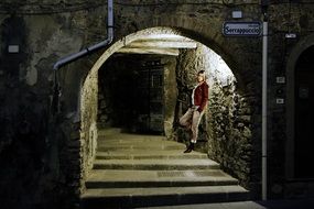 woman on stairs in a lighted tunnel