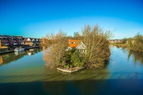 house on an island in the middle of a river in England