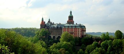 historic castle among green trees in Poland