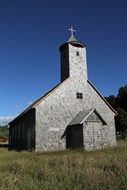 stone church on a green meadow in chile