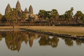 Angkor Wat near the pond among the plants in Cambodia
