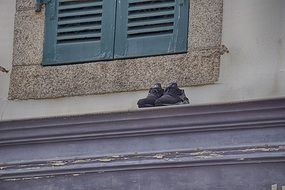 shoes on the curb of the building