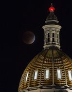 Supermoon in Full Perigee beside of dome of state capitol, usa, colorado, denver