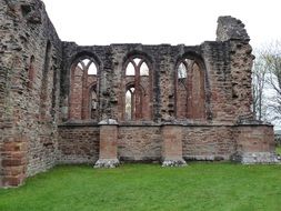 church ruins on a green field in scotland