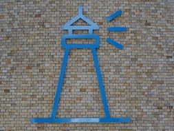 Blue Lighthouse Symbol on brick wall