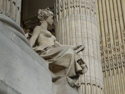 statue of a girl on the facade of a building in France